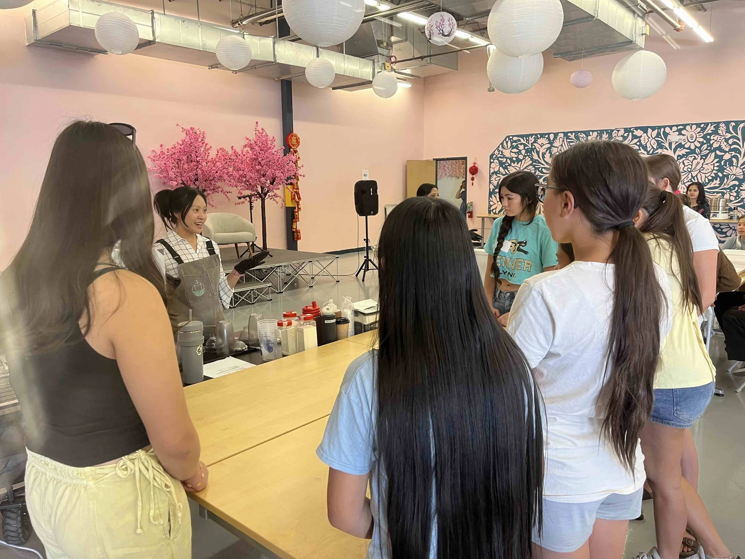 Victoria Lam of Tea Street guiding AANHPI youth on how to make boba in Denver