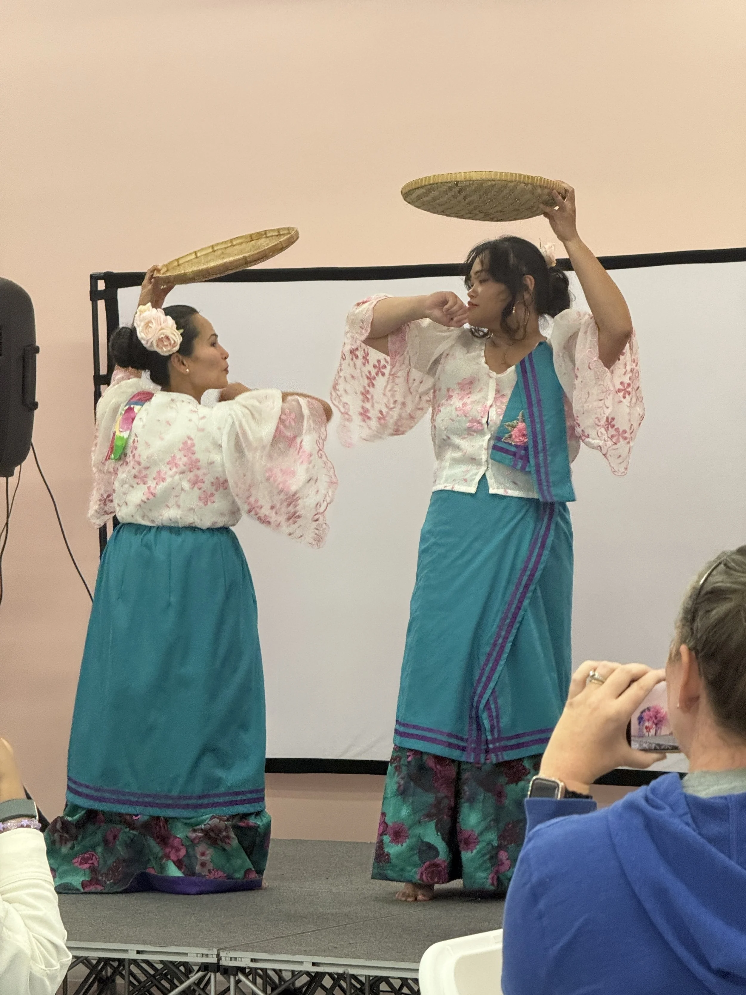 Padayon Cultural FACC  performing traditional Filipino Gaway Gaway dance on stage in light pink room