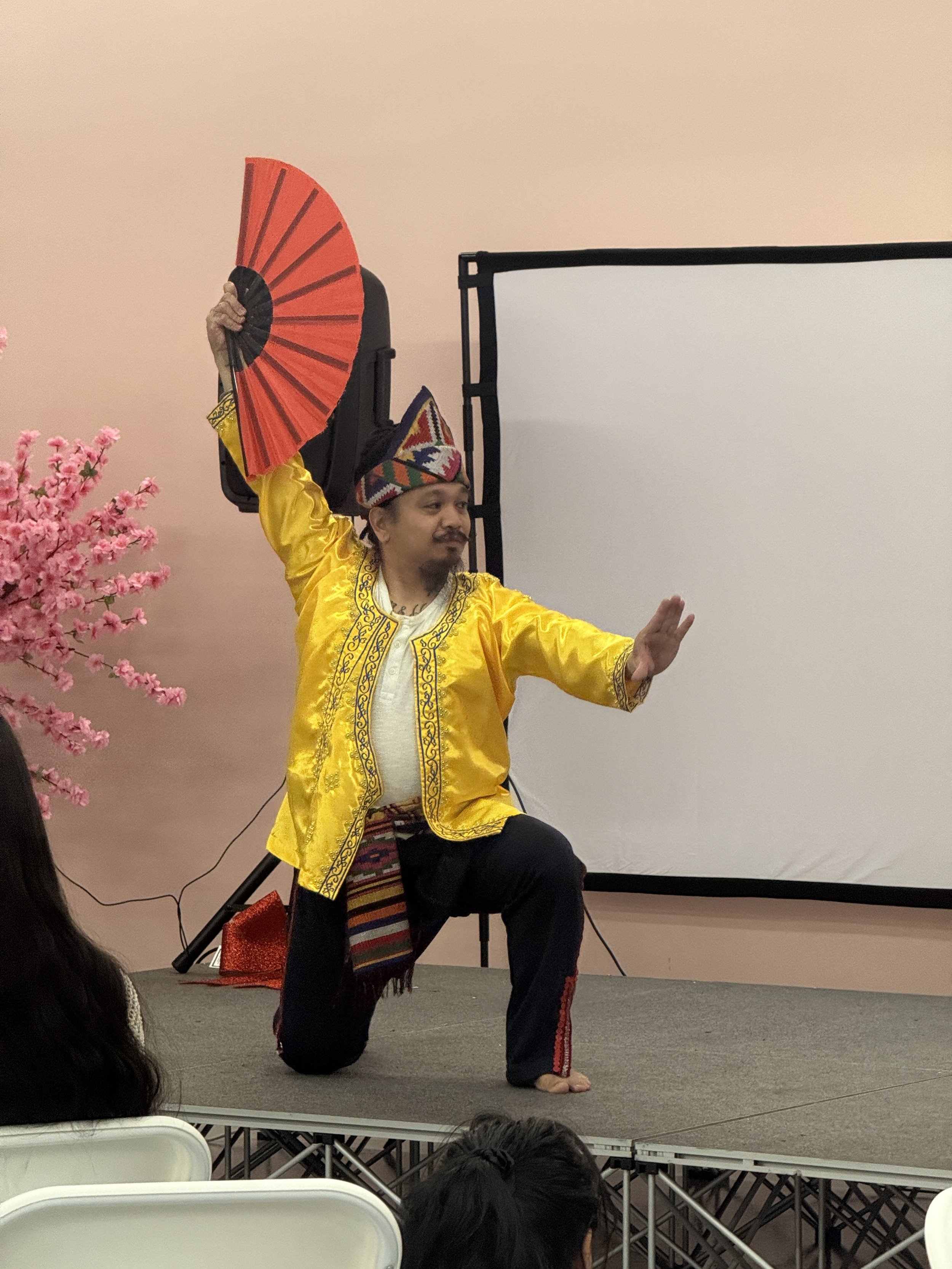 Padayon Cultural FACC performing traditional Filipino Pangalay dances on stage in light pink room