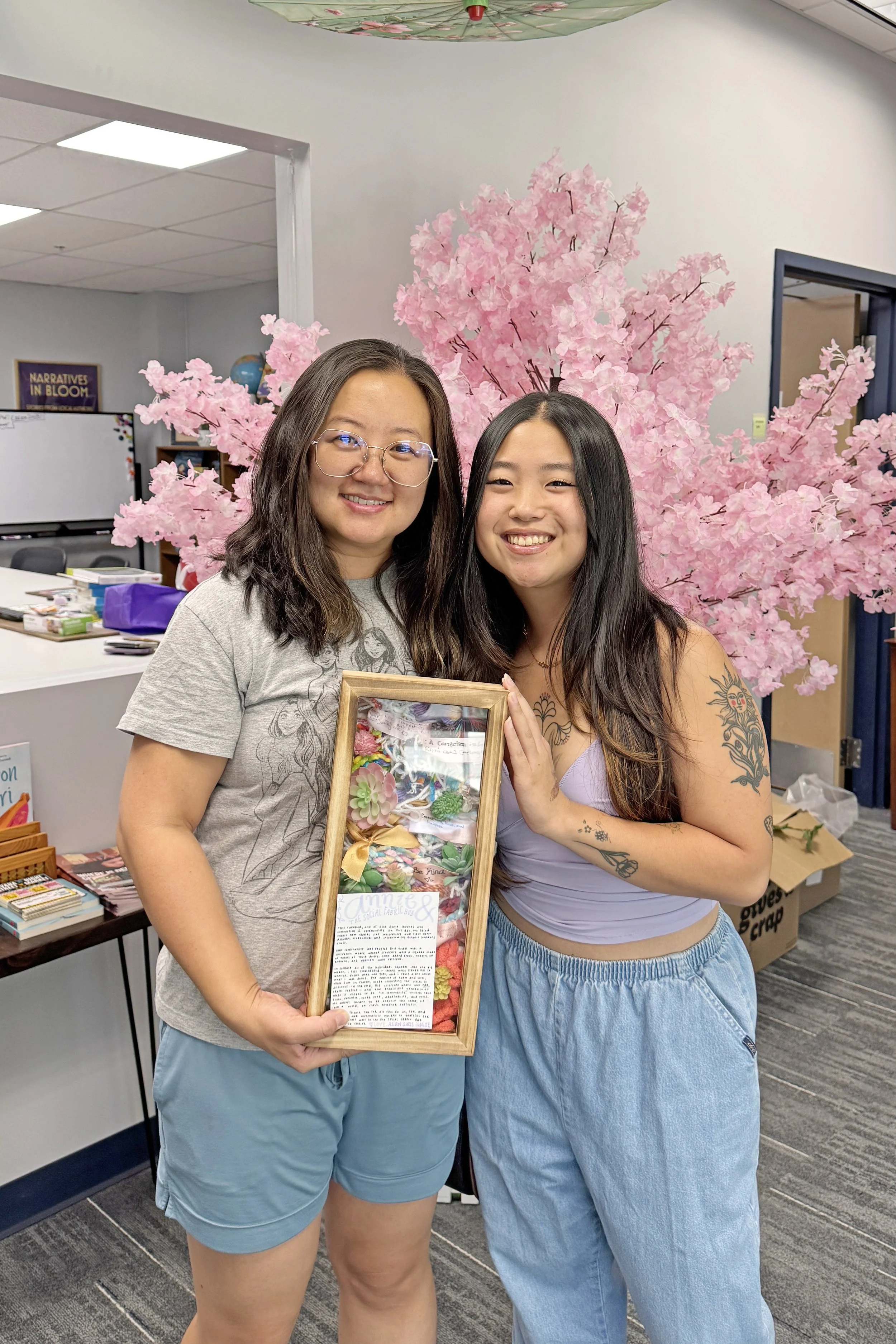 AGI program coordinator, Annabel, and CACEN's founder, Annie, holding collective weave at the social fabric hub