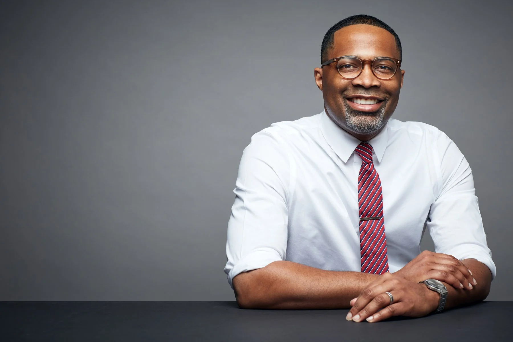 High-end business headshot with clean studio background