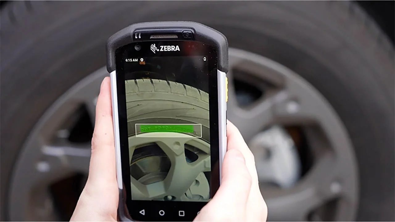 Zebra mobile computer using OCR to capture a serial number from an automotive wheel and tire.