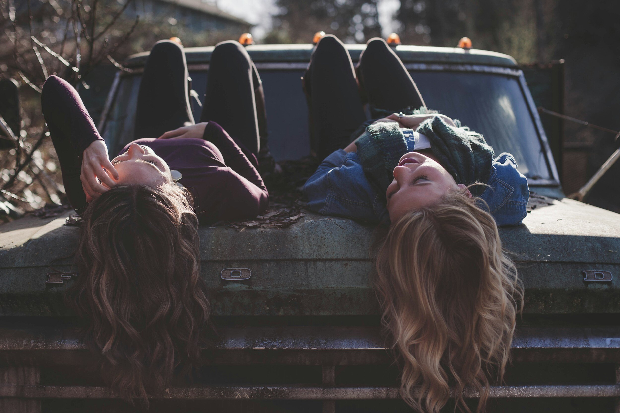 Friends hanging out on the truck realizing they are helping each other being a positive influence.