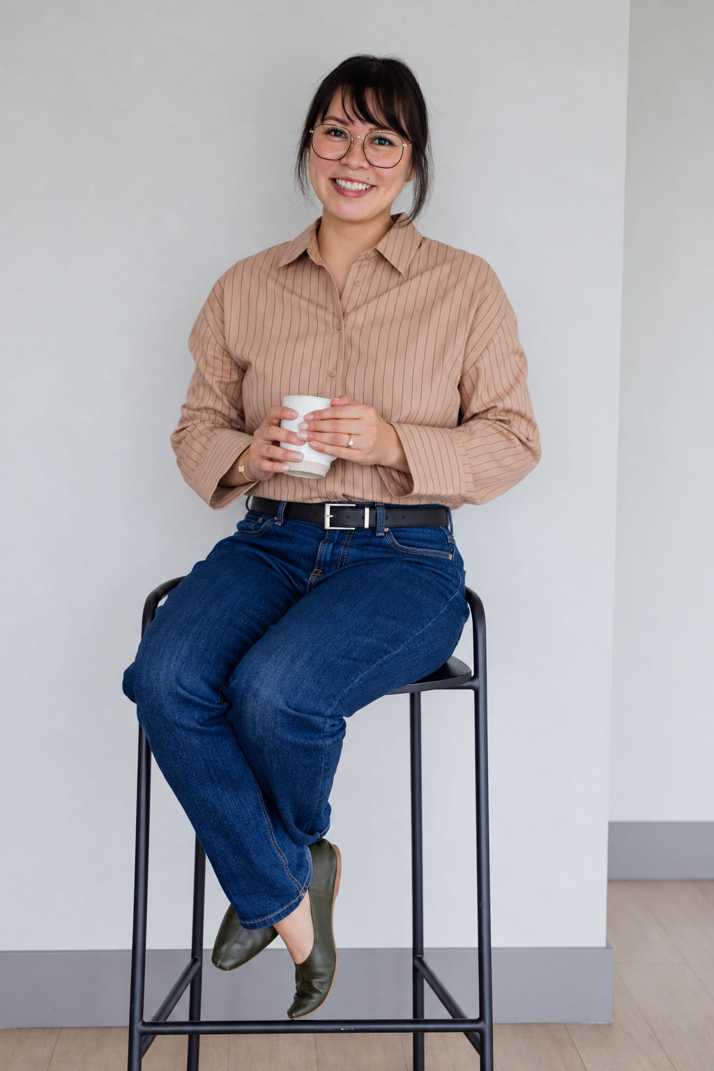 A woman sitting on a stool