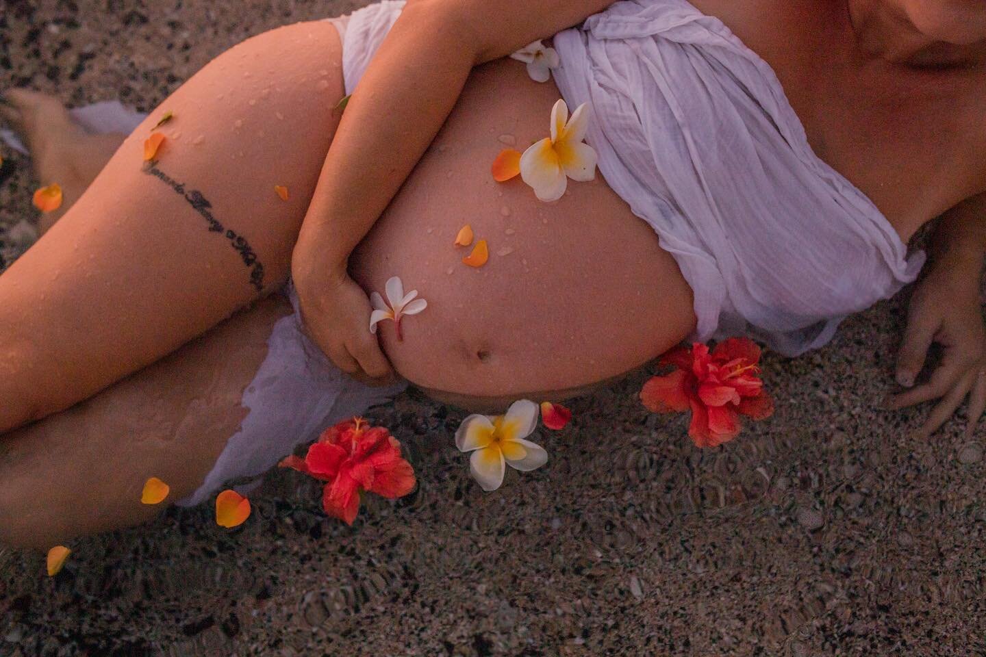 I love this shot. It truly captures a moment that was created, not just a pretty picture. The dark golden light of the setting sun, the sweet smell of plumeria scattered on an expectant mother with the intention of blessing as she basked in the warm 