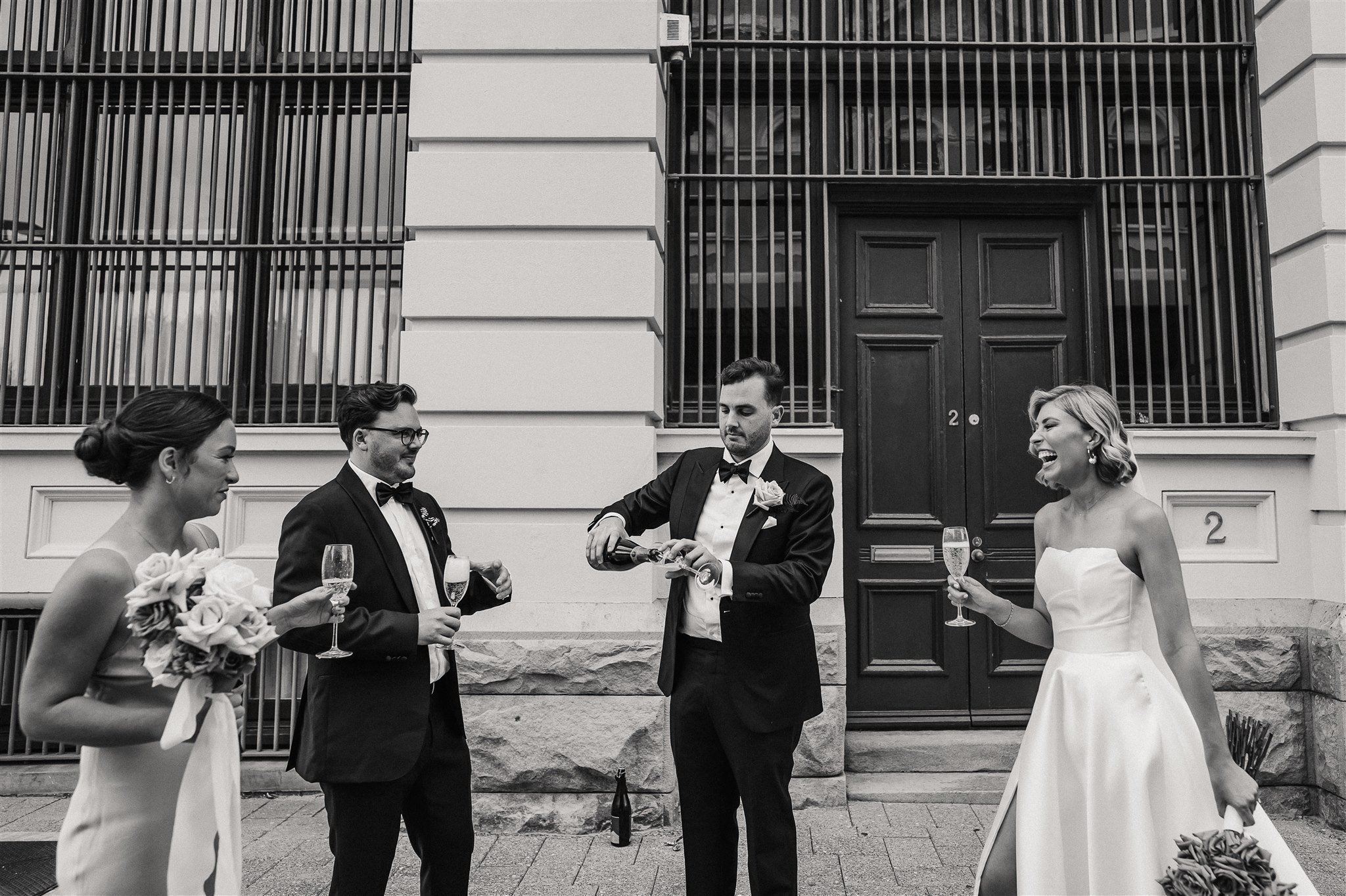  the couple with their groomsman and bridesmaid having a wine party outside the Assembly Yard in Fermantle Australia 