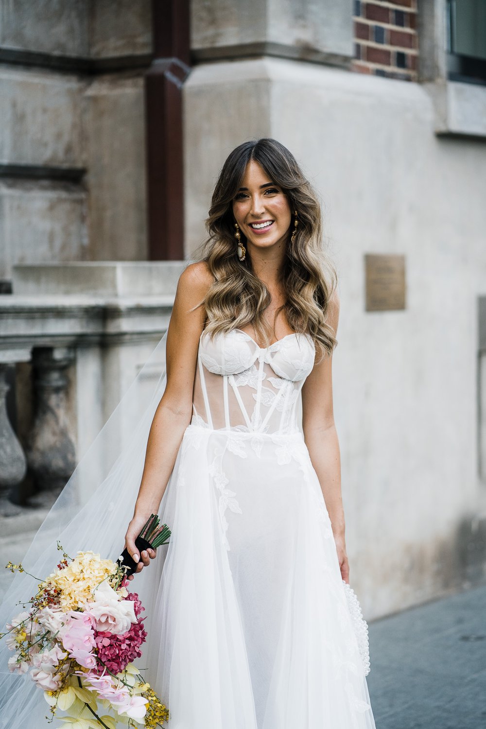  beautiful bride in her stylish wedding dress and holding her fresh flower bouquet 