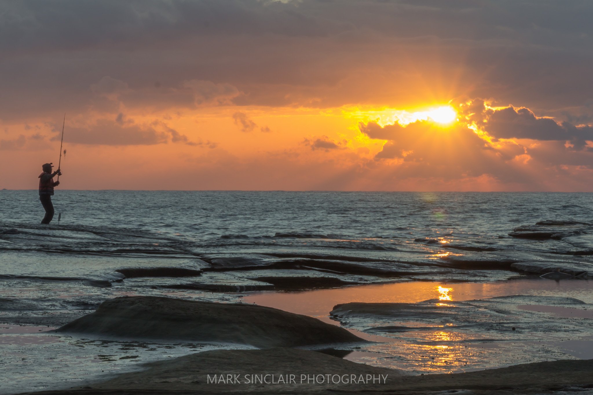   Rock fishing at sunrise off the rocks at the south end of the beach  