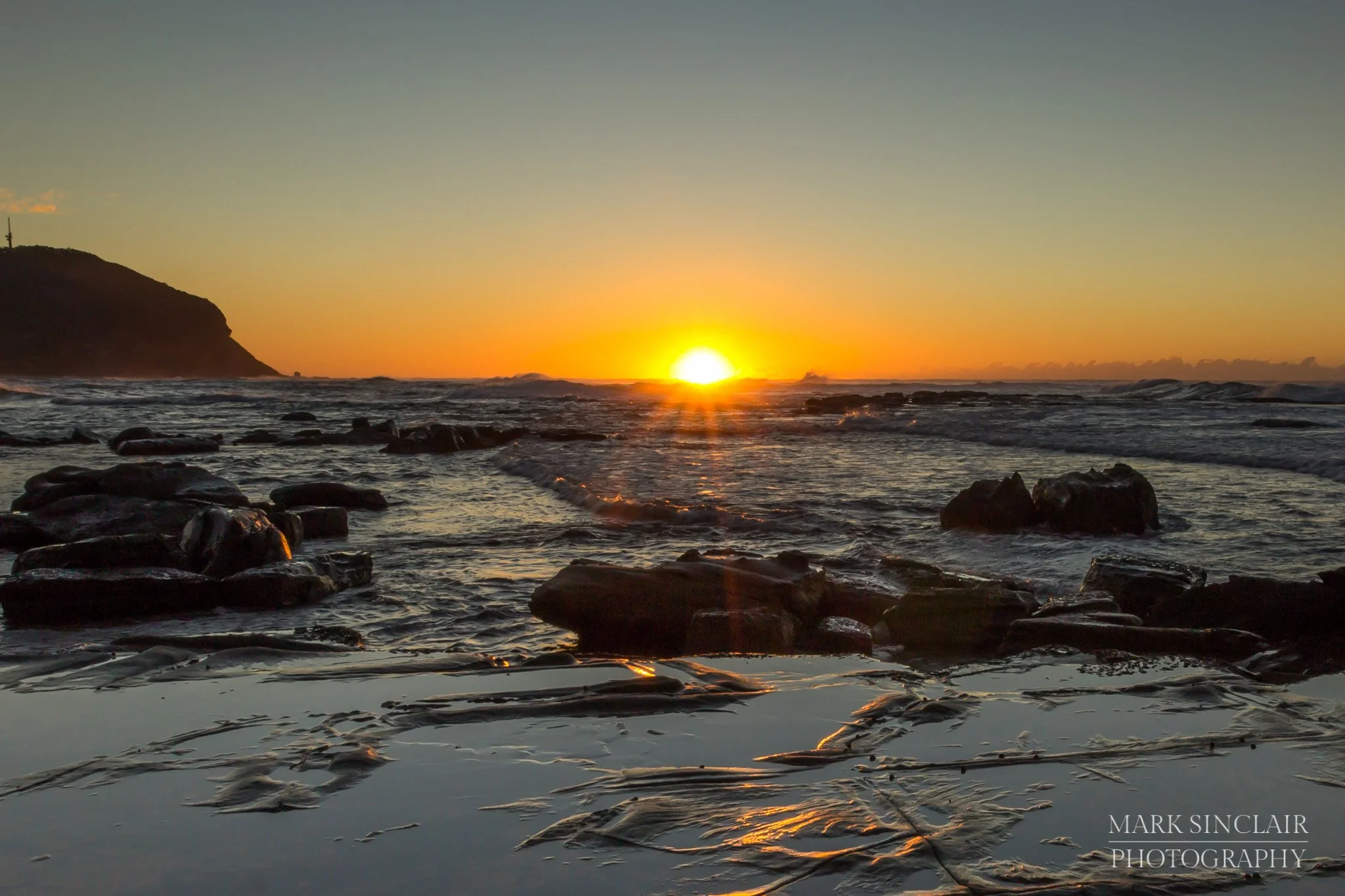   Early morning  sunflare  looking out over the rock shelf  