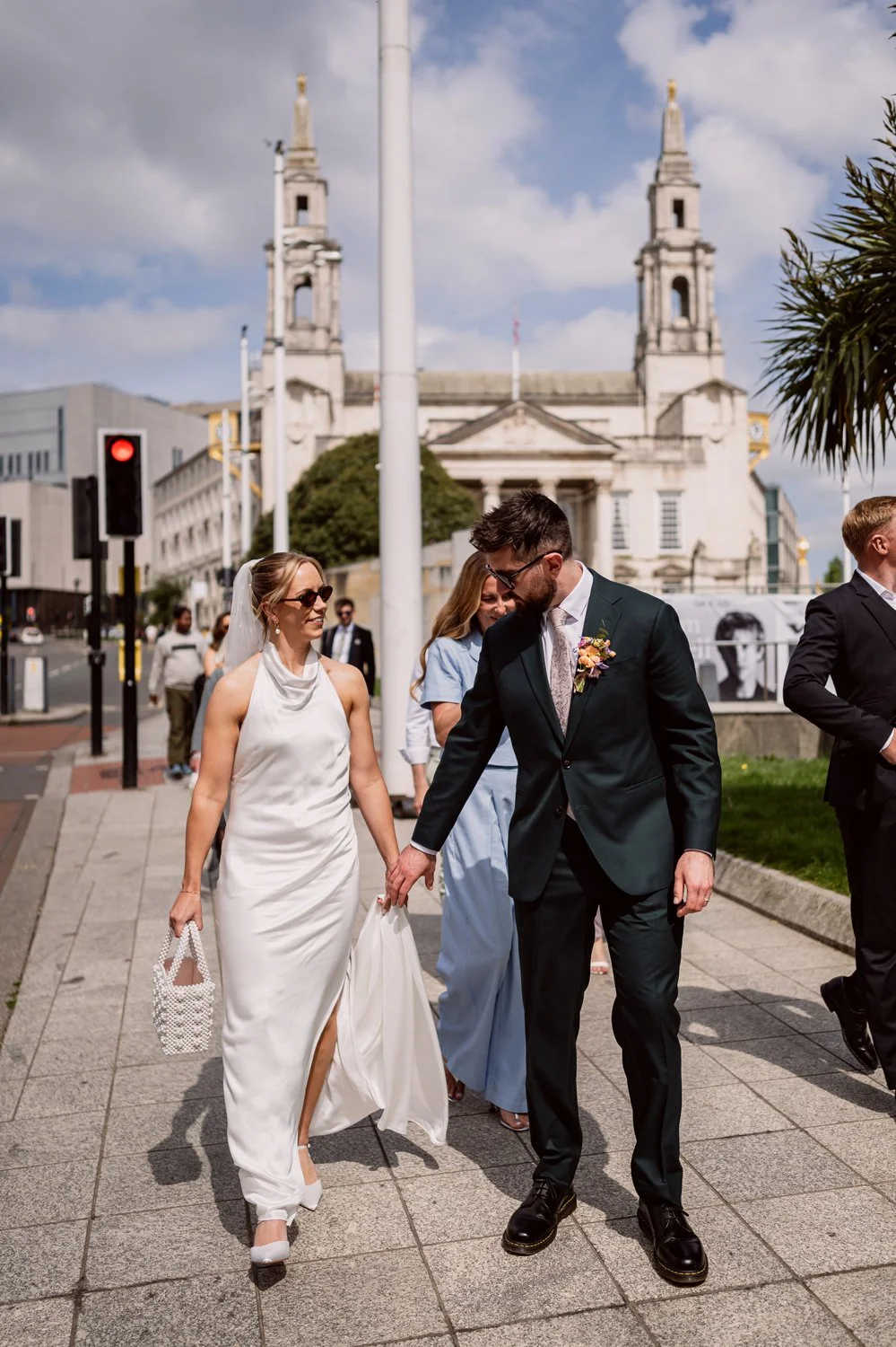 Bride and groom walking through Leeds on their wedding day