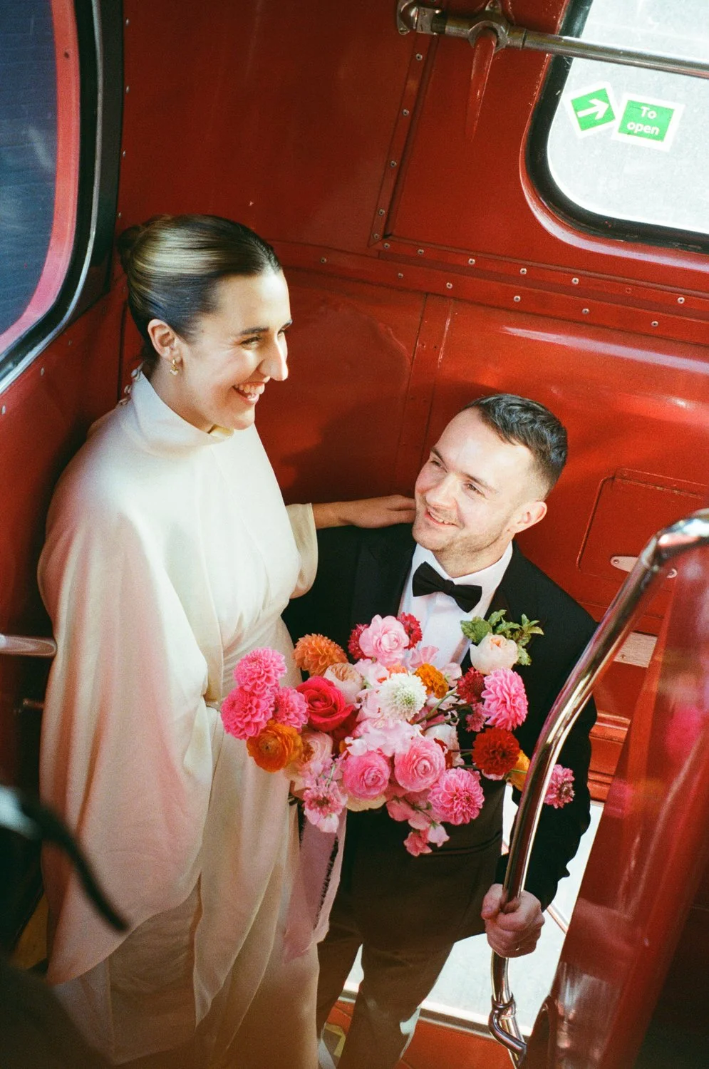 Bride and groom on double decker bus captured by Alternative Birmingham wedding photographer 
