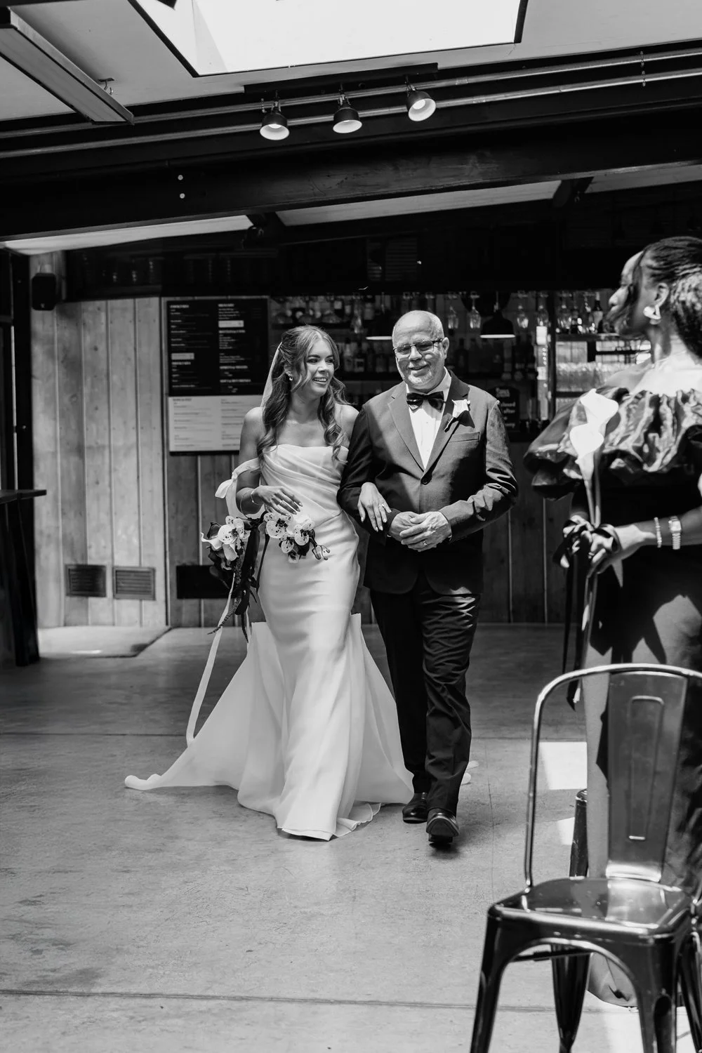 Bride and father walking down the aisle captured by Steph in  her alternative wedding photography style