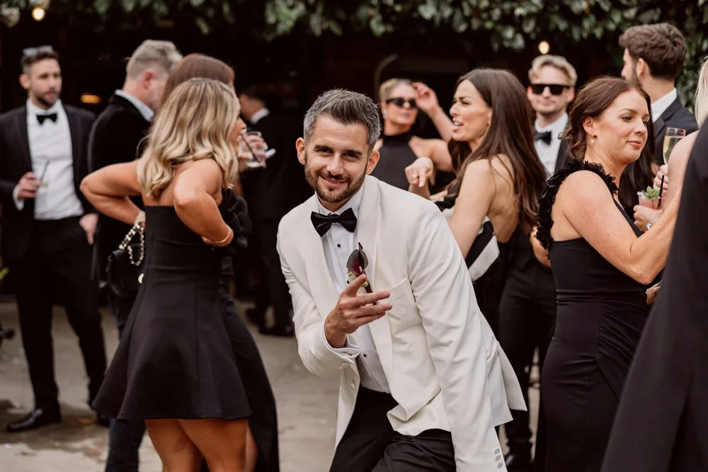 groom dancing and looking at the camera 