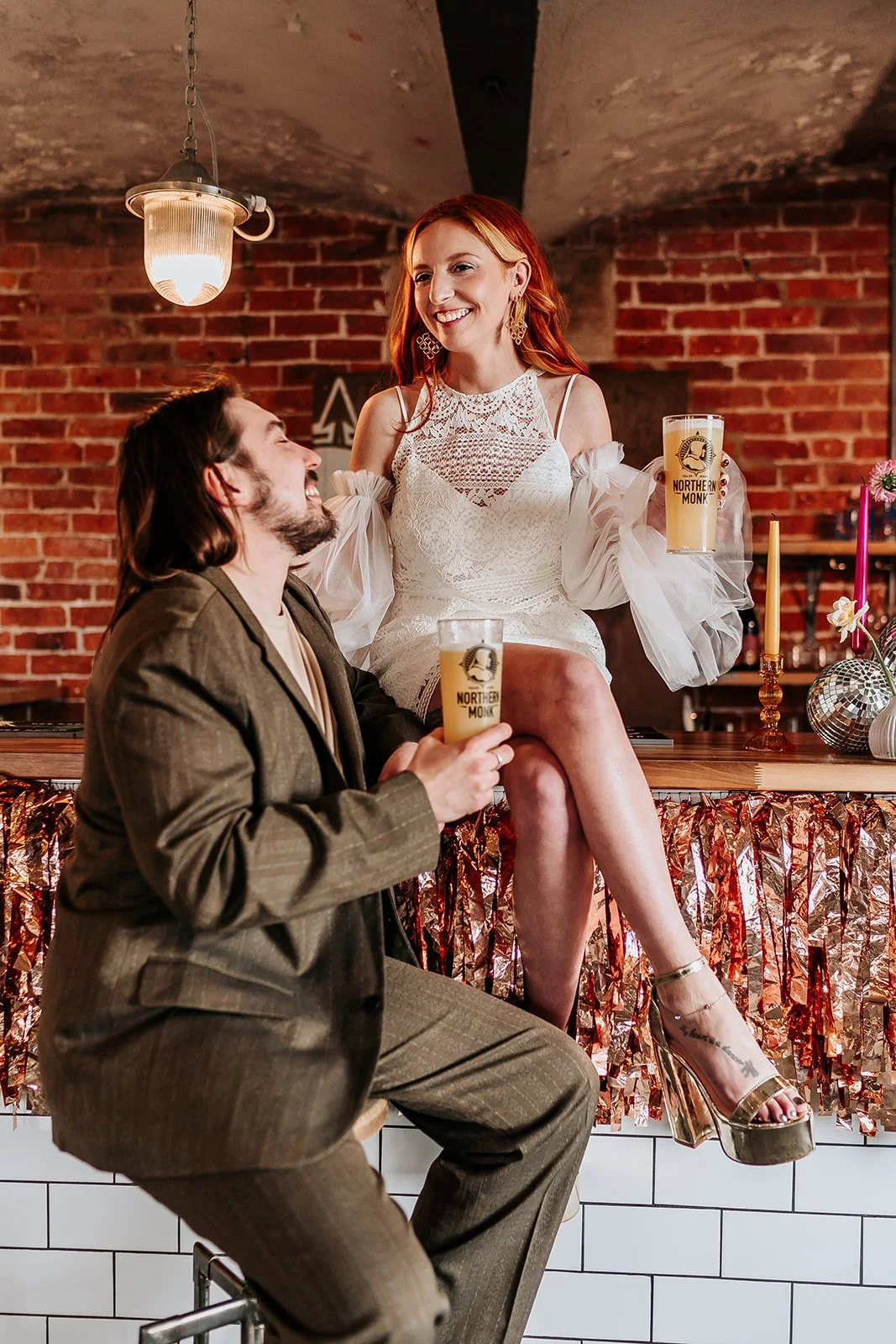 A couple with a pint in their hand during their city wedding in Leeds at Chapter Hall
