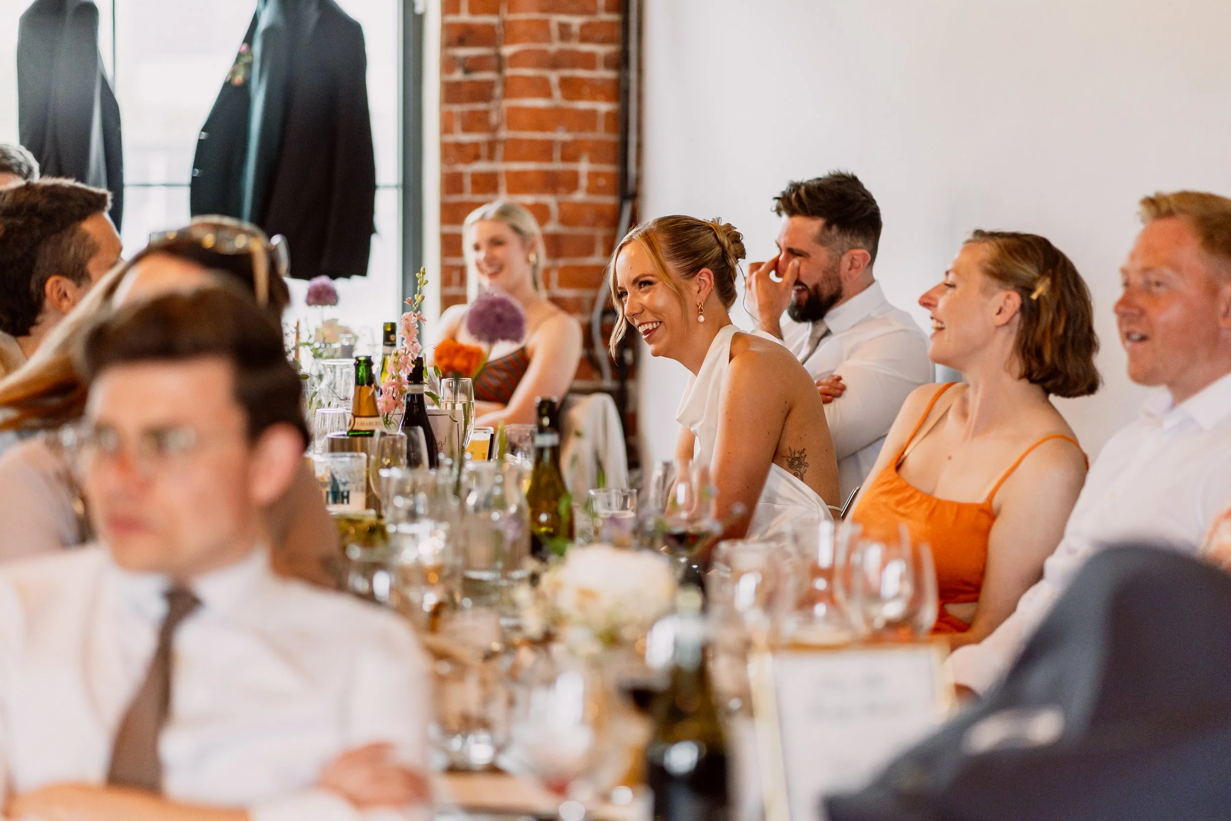 Bride laughing during wedding speeches at Chapter Hall in leeds