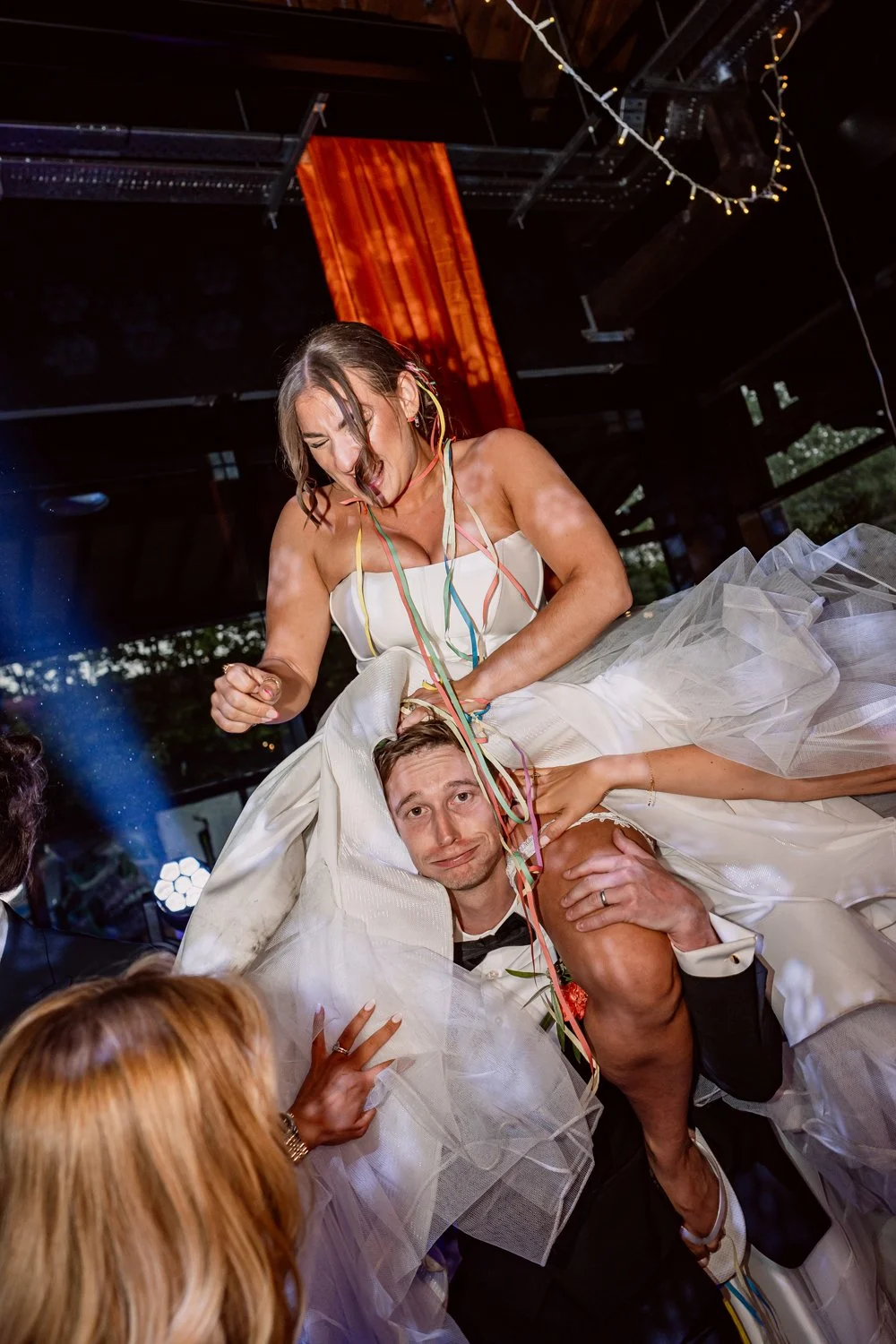 Bride on guests shoulders on the dance floor on their wedding day at The Bond
