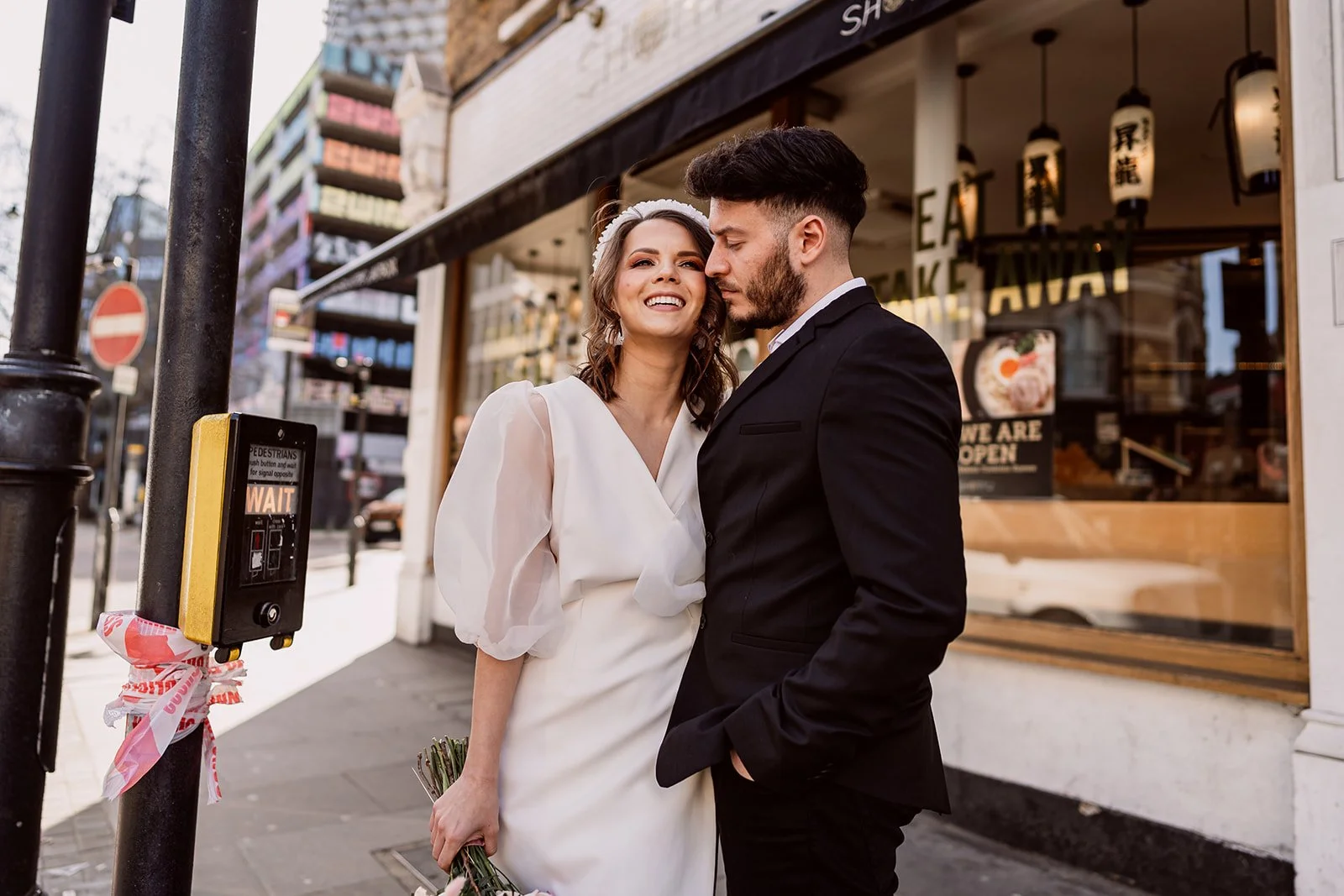 Couple stood at traffic lights in London