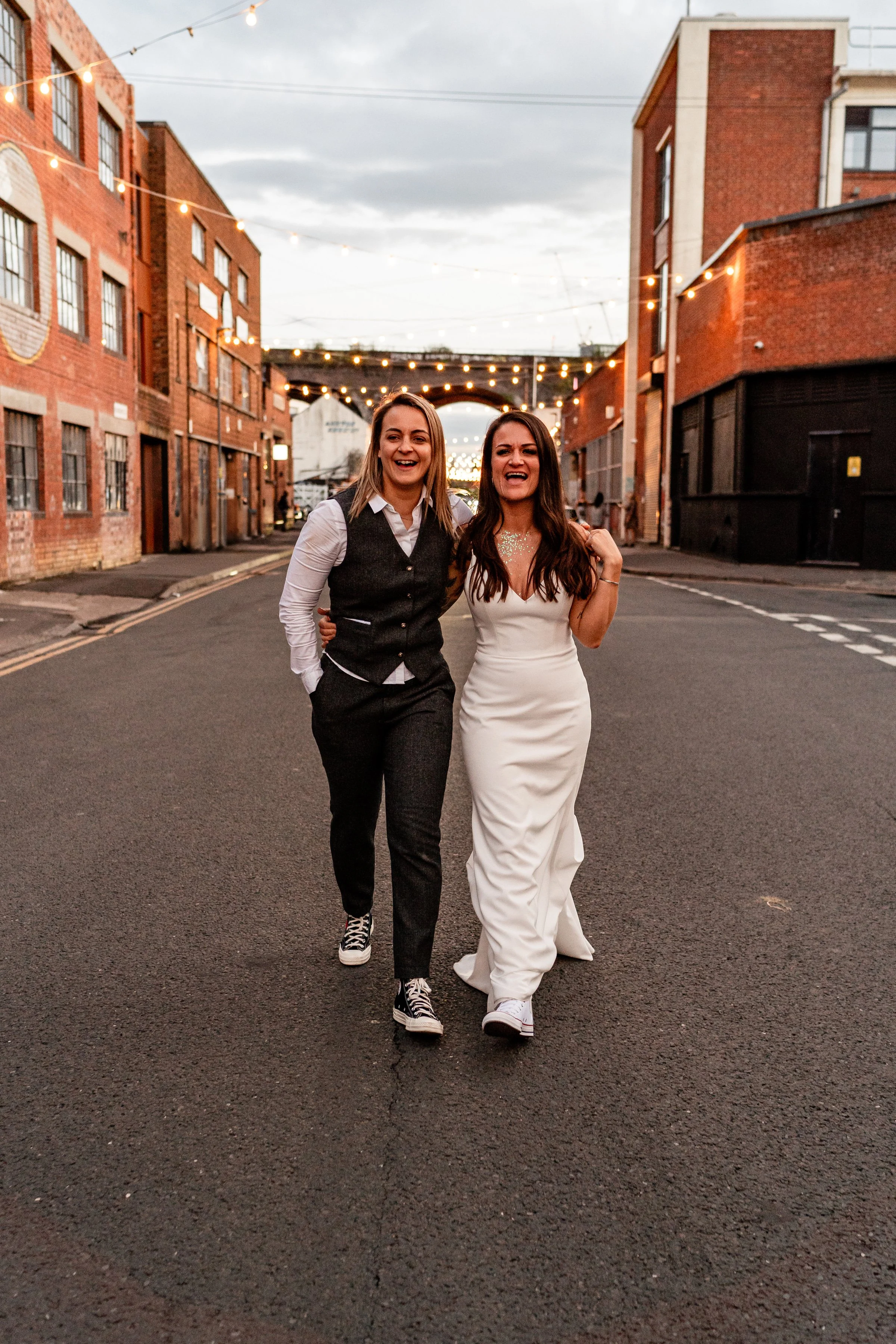 A couple walking down the street during inclusive wedding photography couples portraits