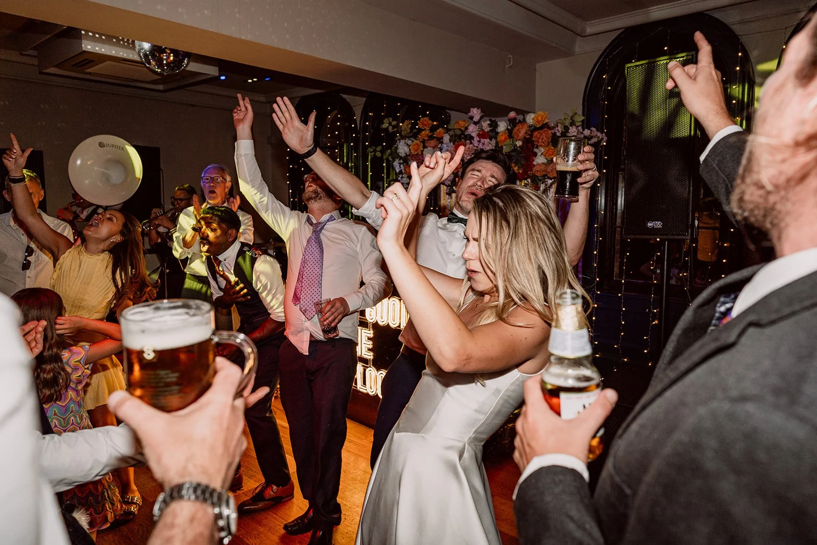 Wedding party dancing and holding drinks at Birmingham wedding