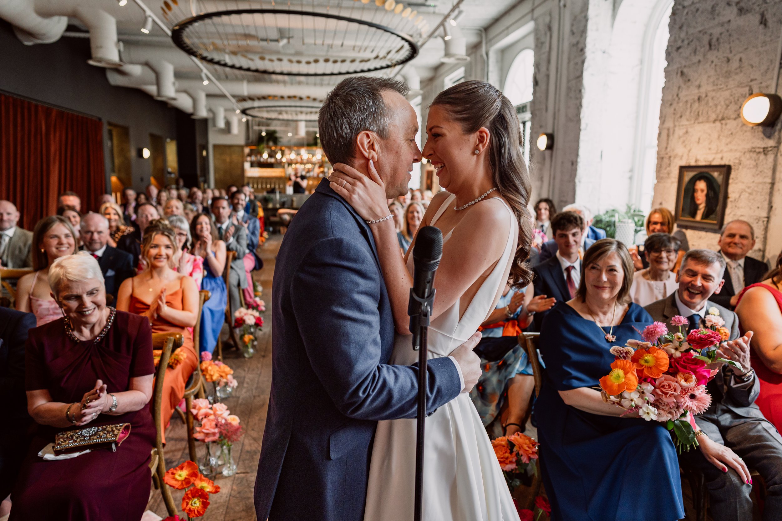 Bride and groom just had first kiss during their ceremony at Kindred Hammersmith