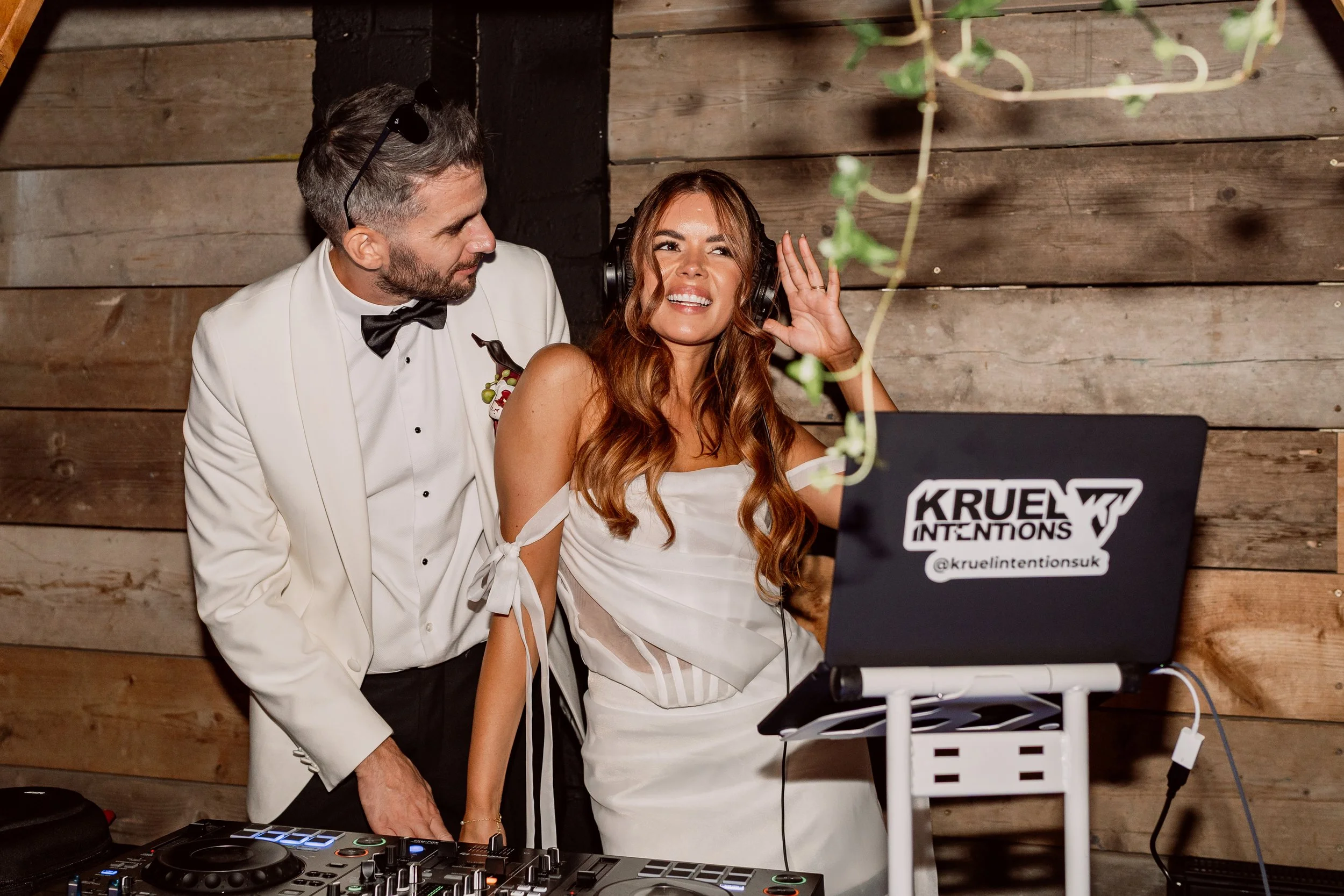 Bride and groom behind DJ decks on wedding day at Shack Revolution