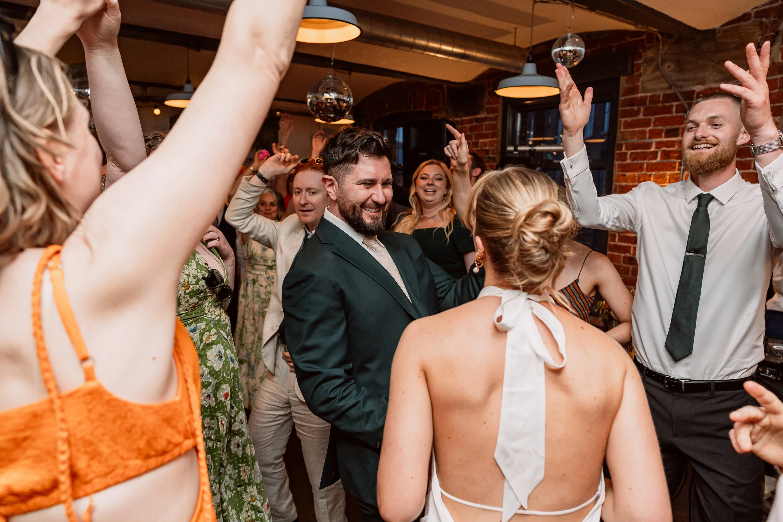 Bride and groom dancing with guests on their wedding day at Chapter Hall in Leeds