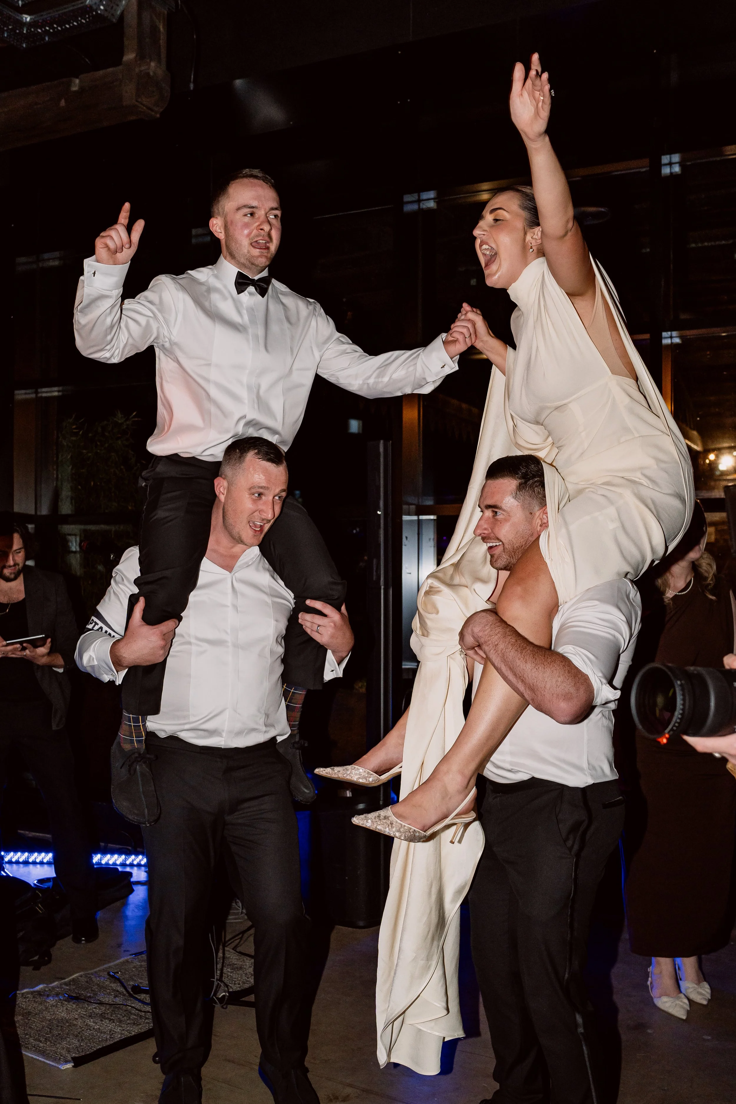 Bride and groom on friends shoulder on the dance floor on their wedding day at The Bond Digbeth