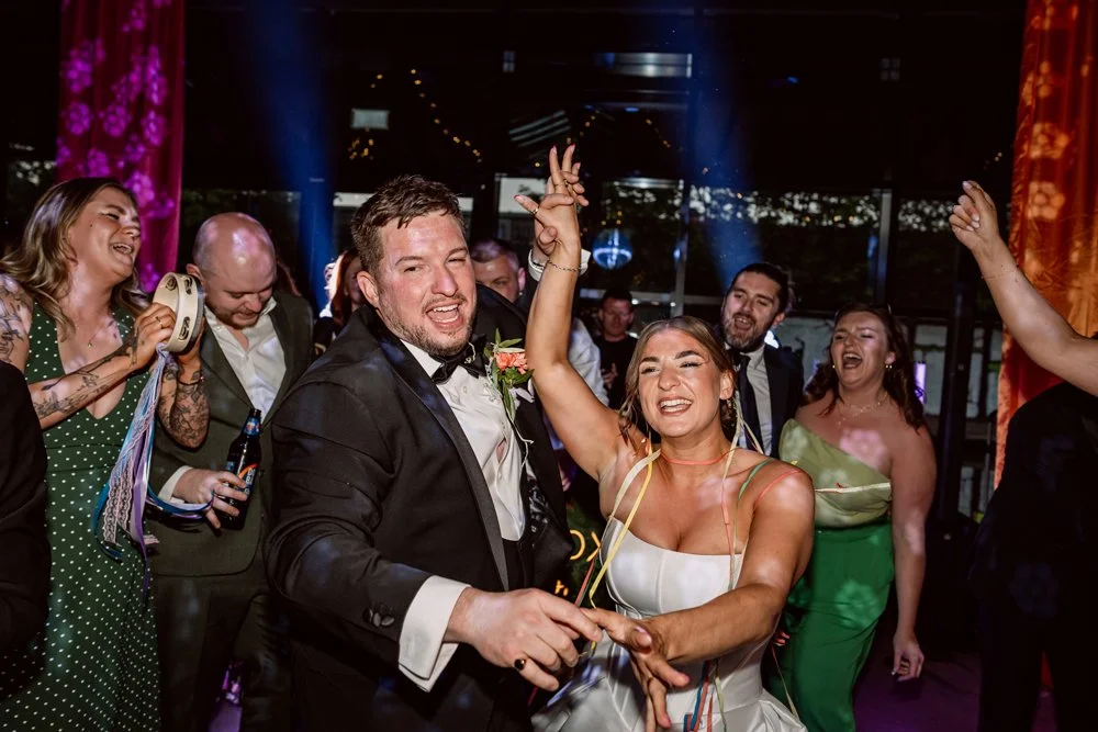 Bride and groom dancing amongst guests on their wedding day