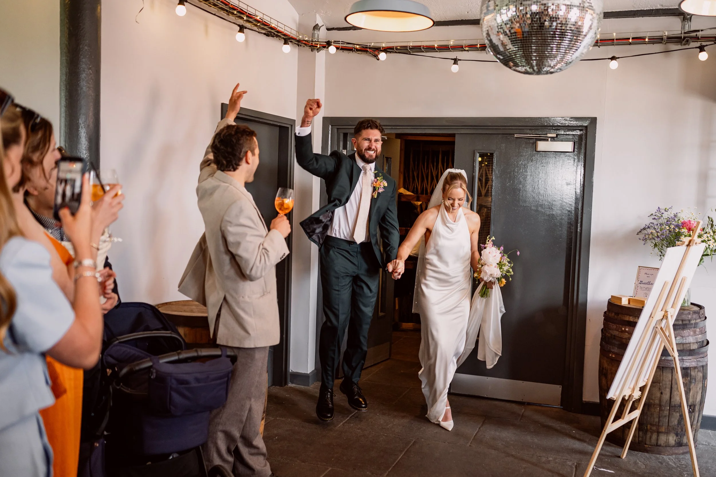 Bride and groom's energetic entrance to their wedding reception at Chapter Hall in Leeds