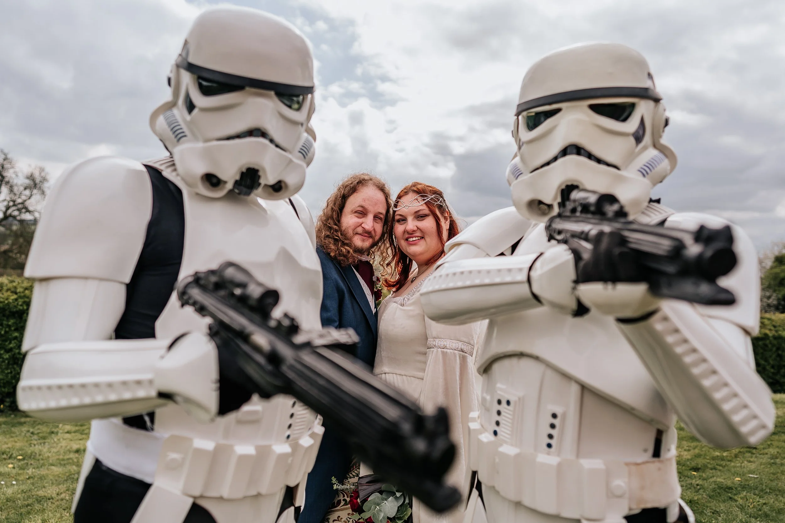A couple standing with star wars characters during inclusive wedding photography