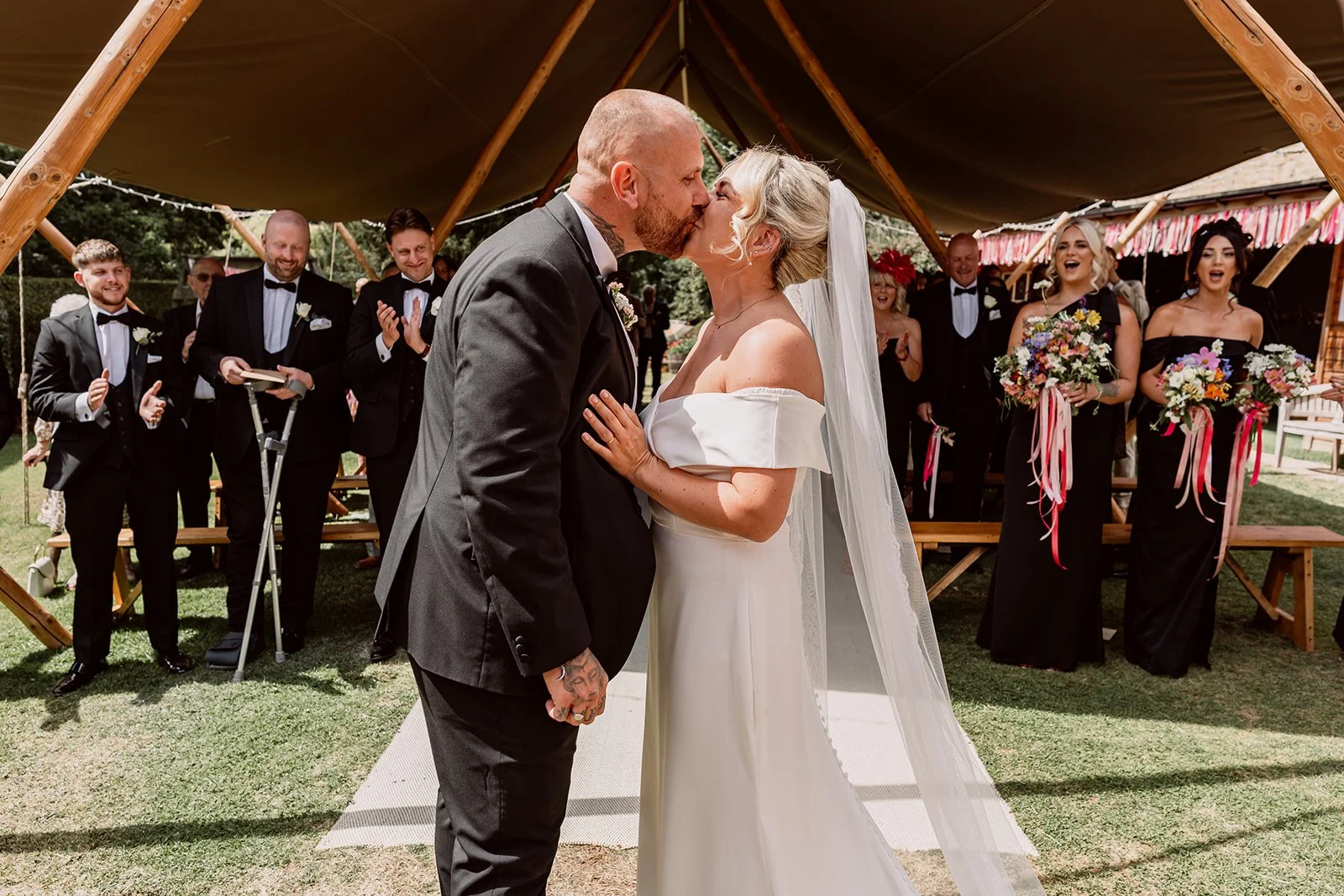 Bride and groom kissing during ceremony at wedding in Birmingham