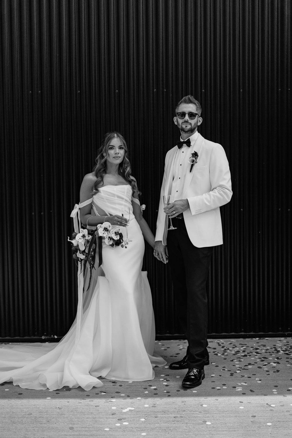 Bride and groom looking down the camera for a portrait