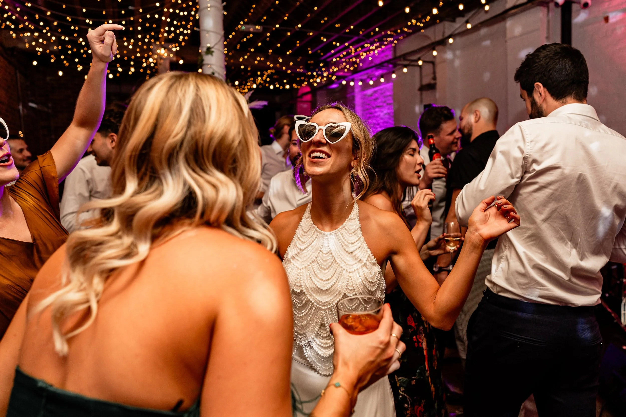 Bride dancing with friends on wedding day at 100 Barrington in London
