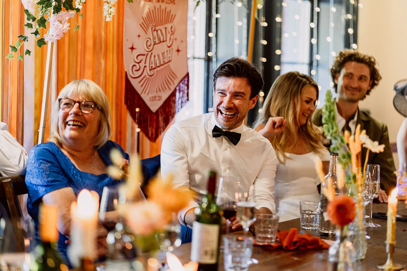 Wedding party sat smiling during speeches at Birmingham wedding