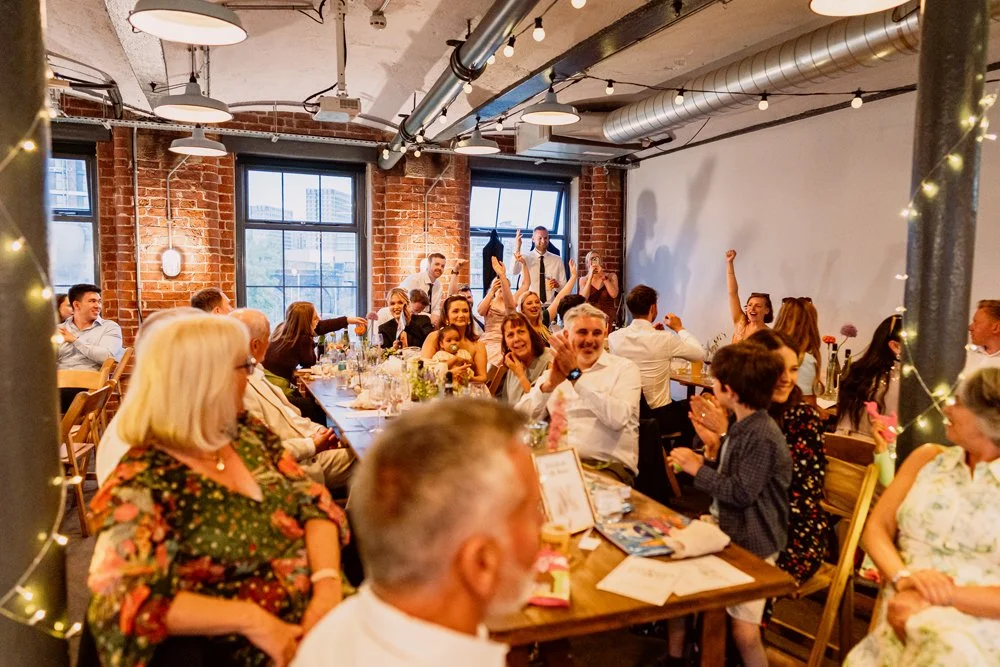 Guests celebrating winning pub quiz on wedding at Chapter Hall in Leeds
