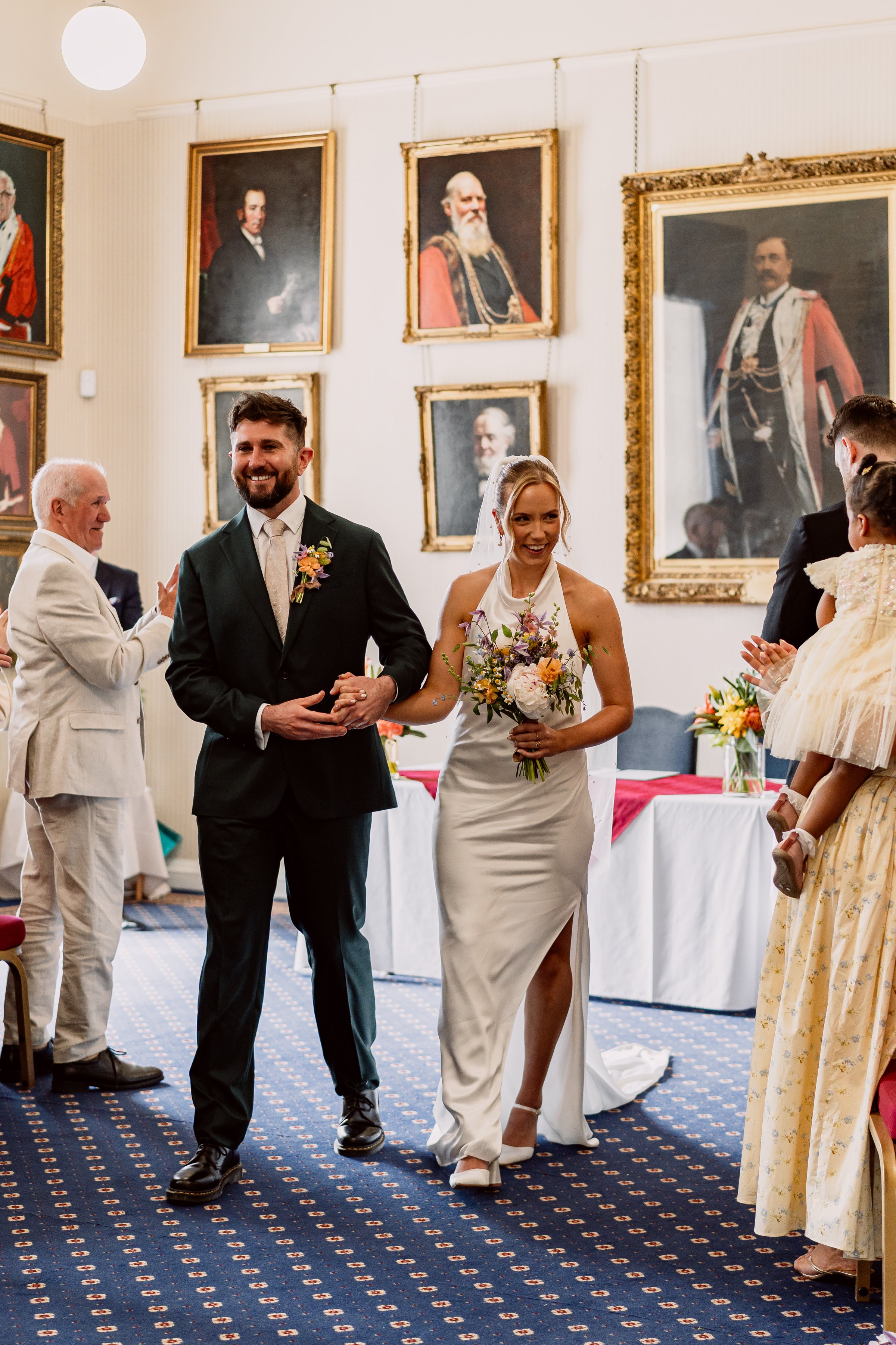 Bride and groom walking up the aisle at Leeds Town Hall