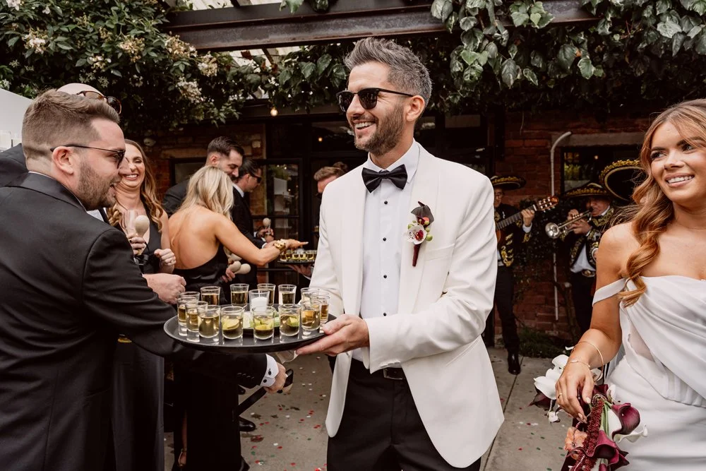 groom giving out tequila shots during alternative wedding reception