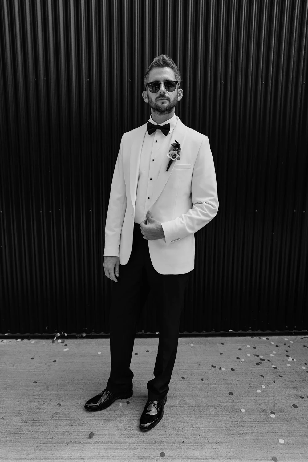 Groom looking down camera on alternative wedding