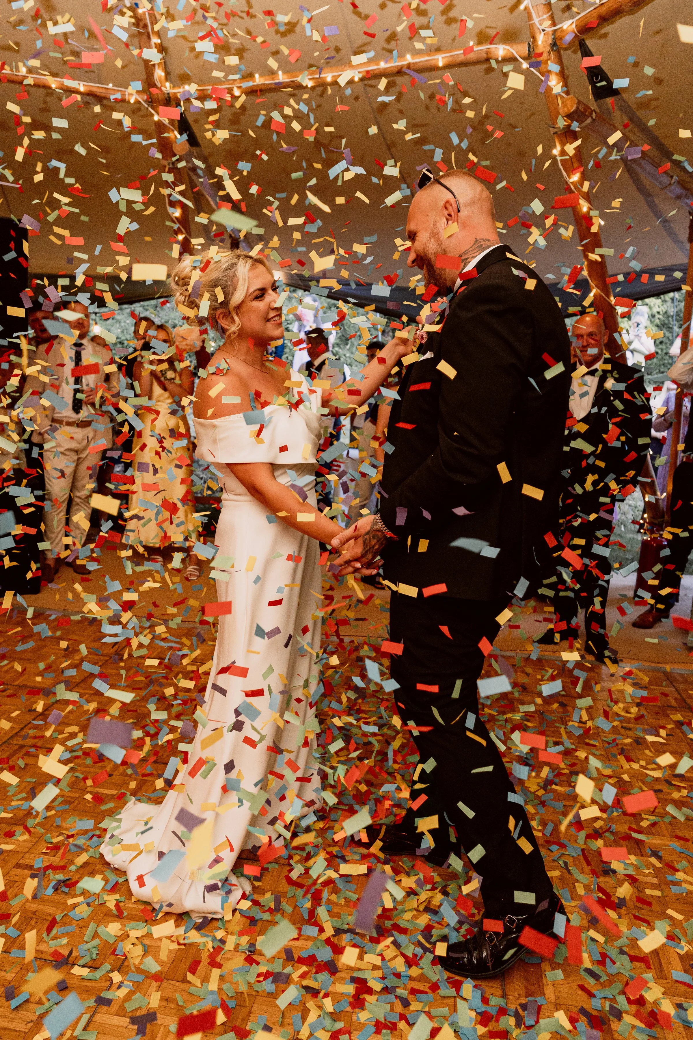 Bride and groom dancing whilst confetti canon gone off