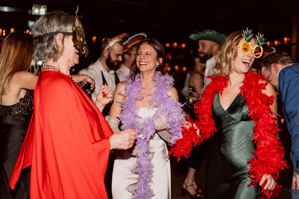 Bride and guests in fancy dress dancing at wedding in Birmingham