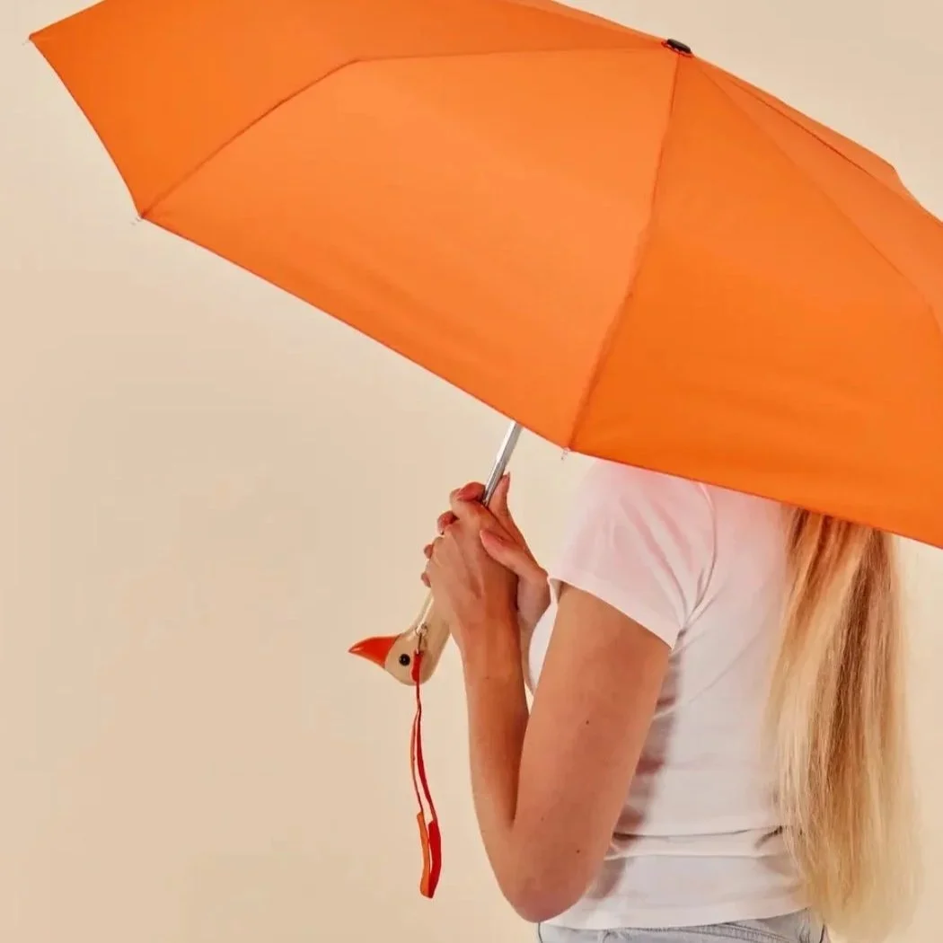 Stocking Stuffers in Providence: A bright orange umbrella with a whimsical handle shaped like a duck head