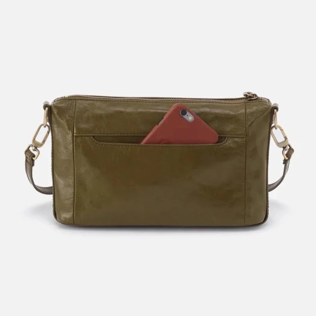 Spring fashion in Providence: an olive crossbody bag, with a cellphone peeking out of its exterior pocket.