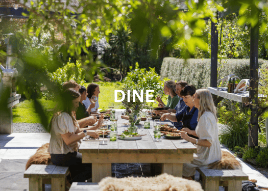 Guests dining at Hapuku Kitchen, New Zealand in the leafy outdoor dining area