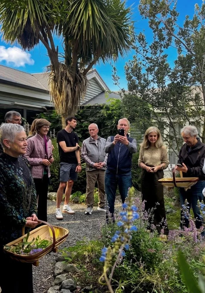 Guests foraging and harvesting from the Hapuku Kitchen gardens for their evening meal, New Zealand
