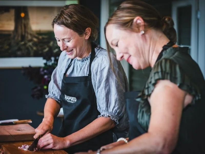 Guests at Hapuku Kitchen cooking school preparing ingredients