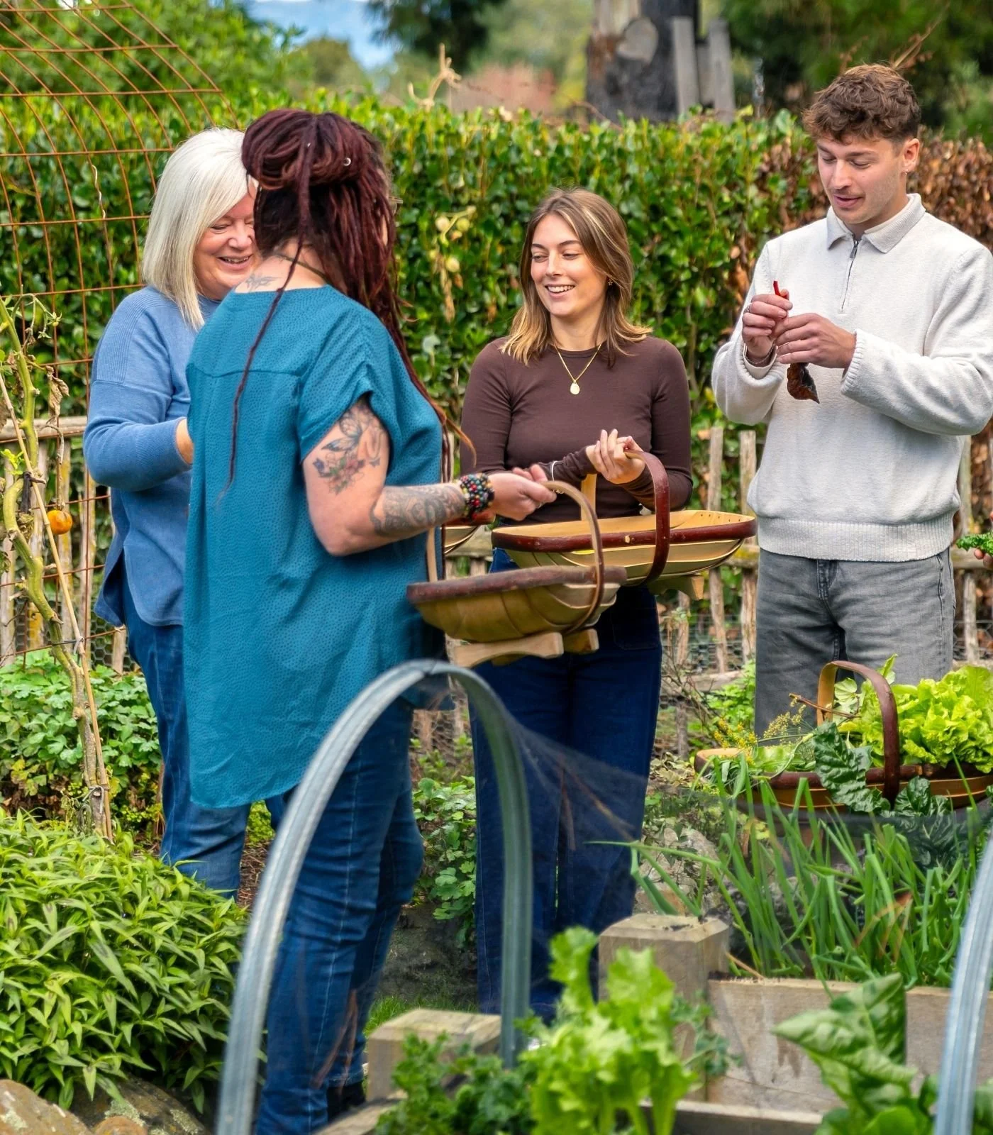 Guests at cooking school, Hapuku Kitchen, picking fresh ingredients for their own feast