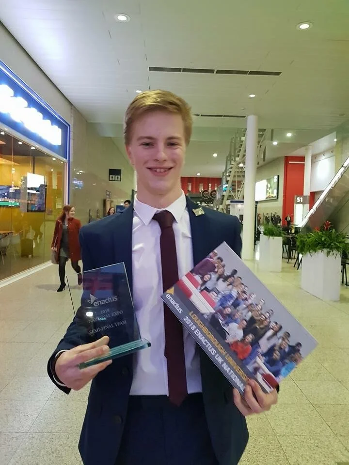 Enactus Nationals Trophy and Photo.JPG