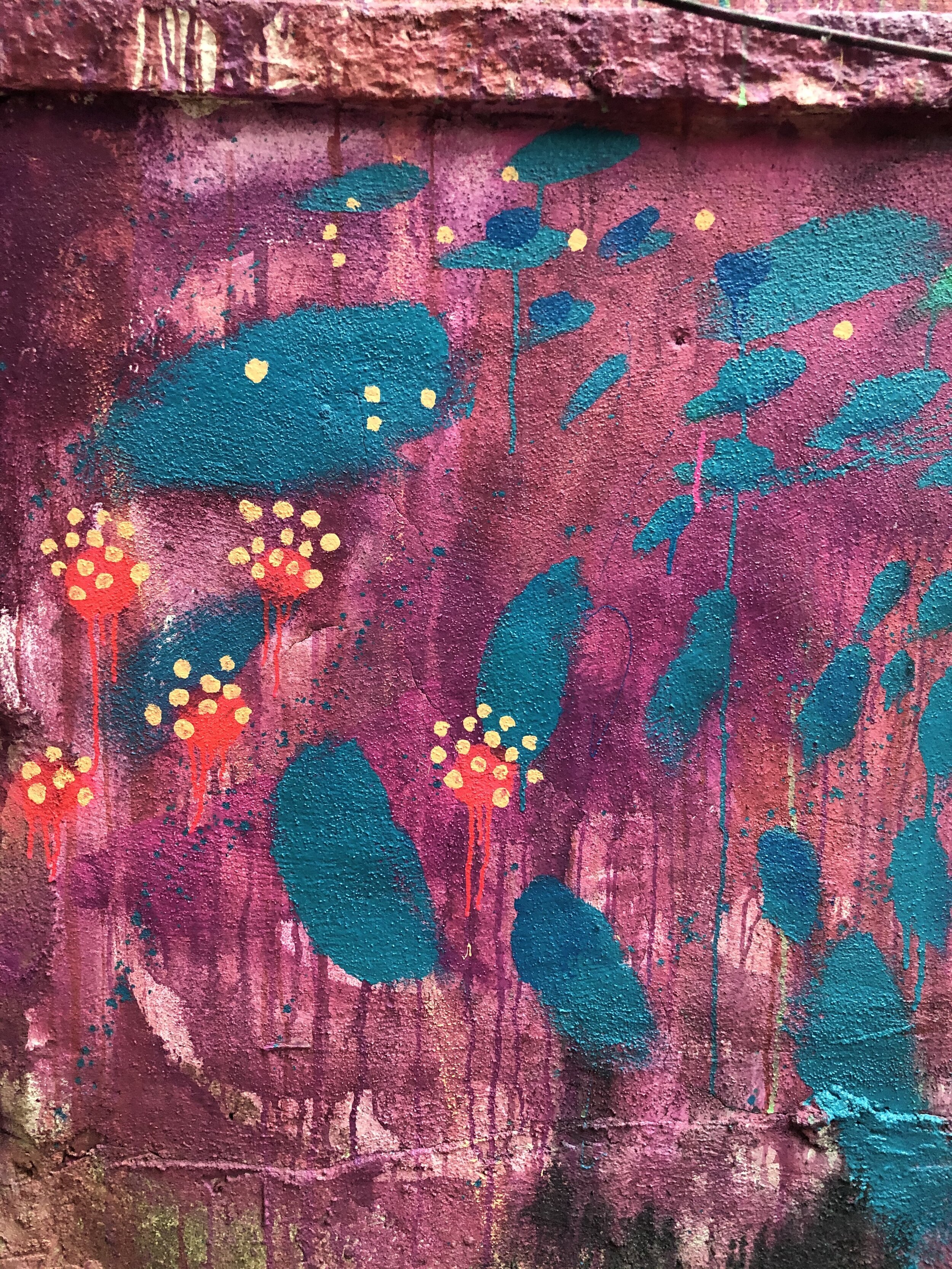I was planning to do an abstract pattern, and keep it really loose. I had the client have fun and help me lay down the purple backdrop. As I started adding the green swath of paint, he said he had one request: could I paint his favorite flower, the t