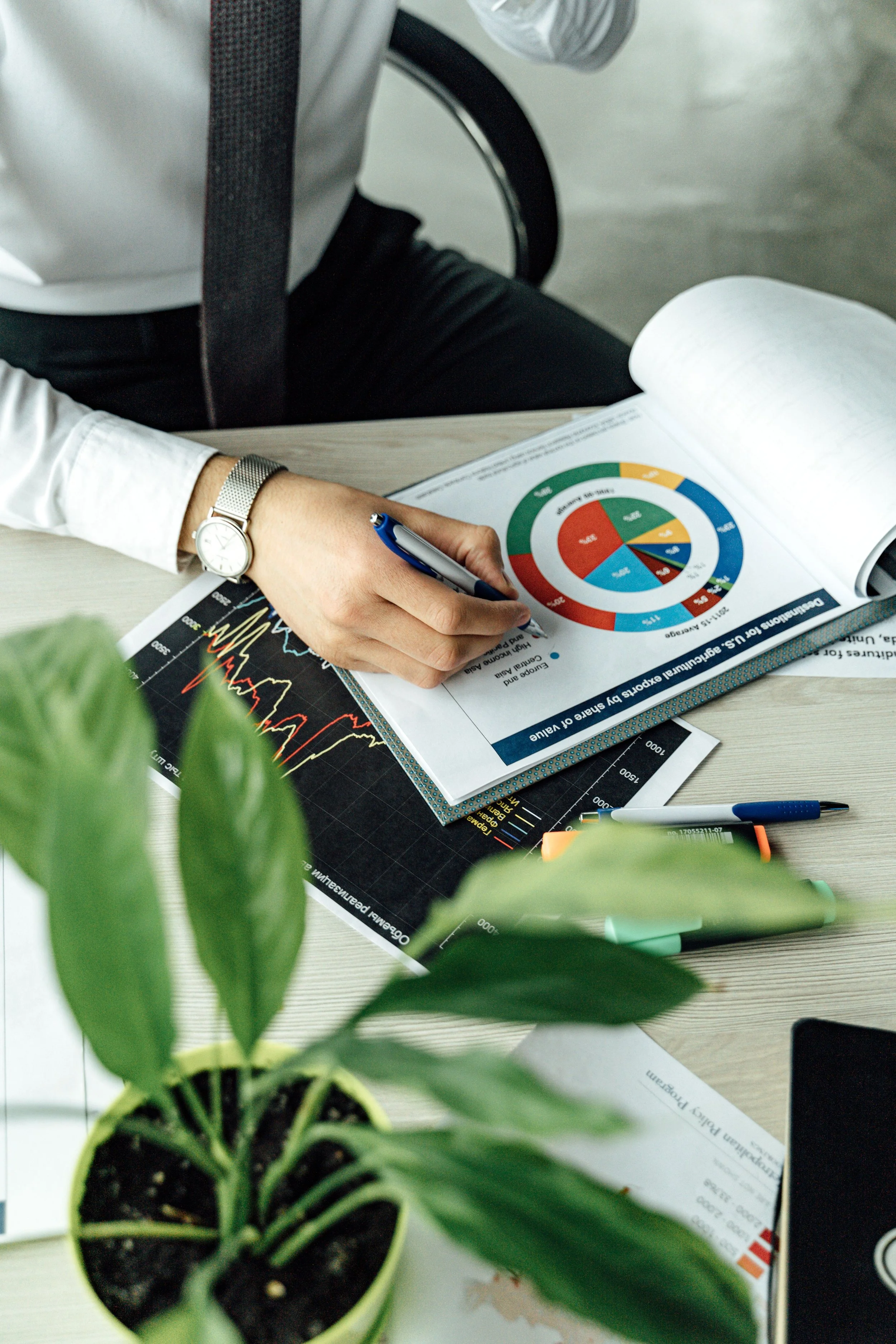 womans hand writing marketing documents