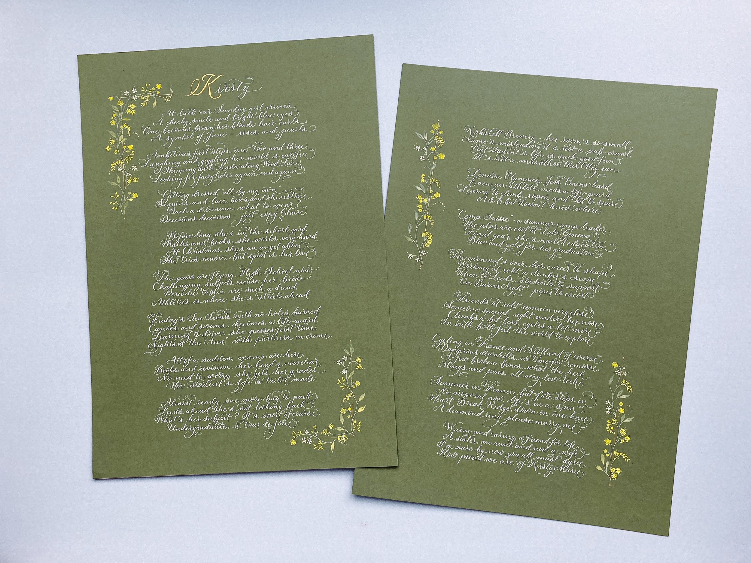 A long calligraphy poem written over 2 pages of A3 green paper in white ink and illustrated with delicate yellow flowers | By Moon & Tide Calligraphy UK